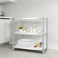 A three-tier kitchen organizer shelf with a chrome silver metal frame and white shelves, styled with kitchenware and food items in a modern kitchen setting.