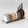 Dish rack with plates, bowls, and frying pans on a white background