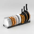 Dish rack with plates, bowls, and frying pans on a white background