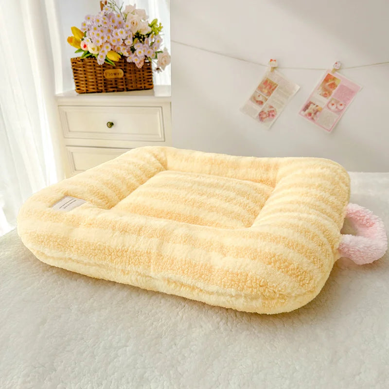 Fluffy pet bed on a light-colored surface with a decorative background