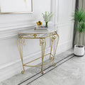 Gold decorative console table in a room with white walls and a plant.