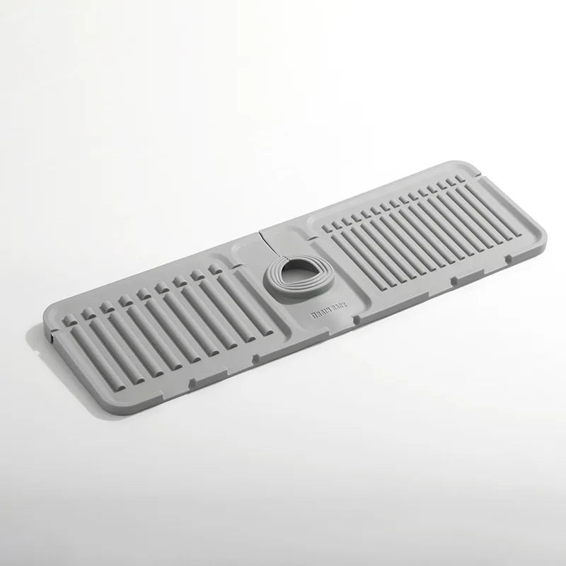 Gray rubber mat with drainage holes on a white background