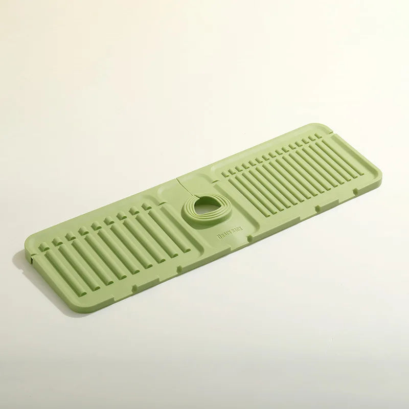 Green bath mat with textured surface and central circular hole on a light beige background