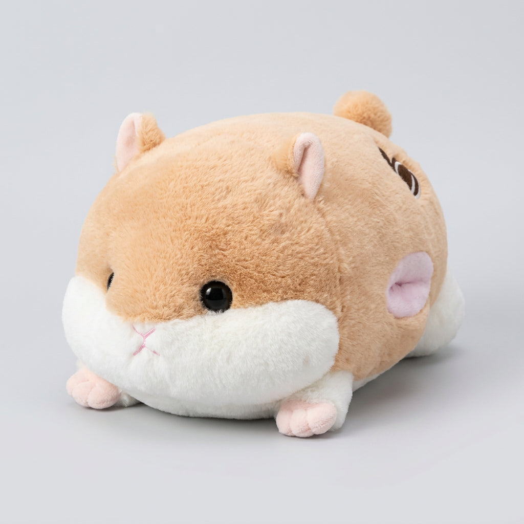 Plush toy resembling a hamster on a brown surface with a blurred background