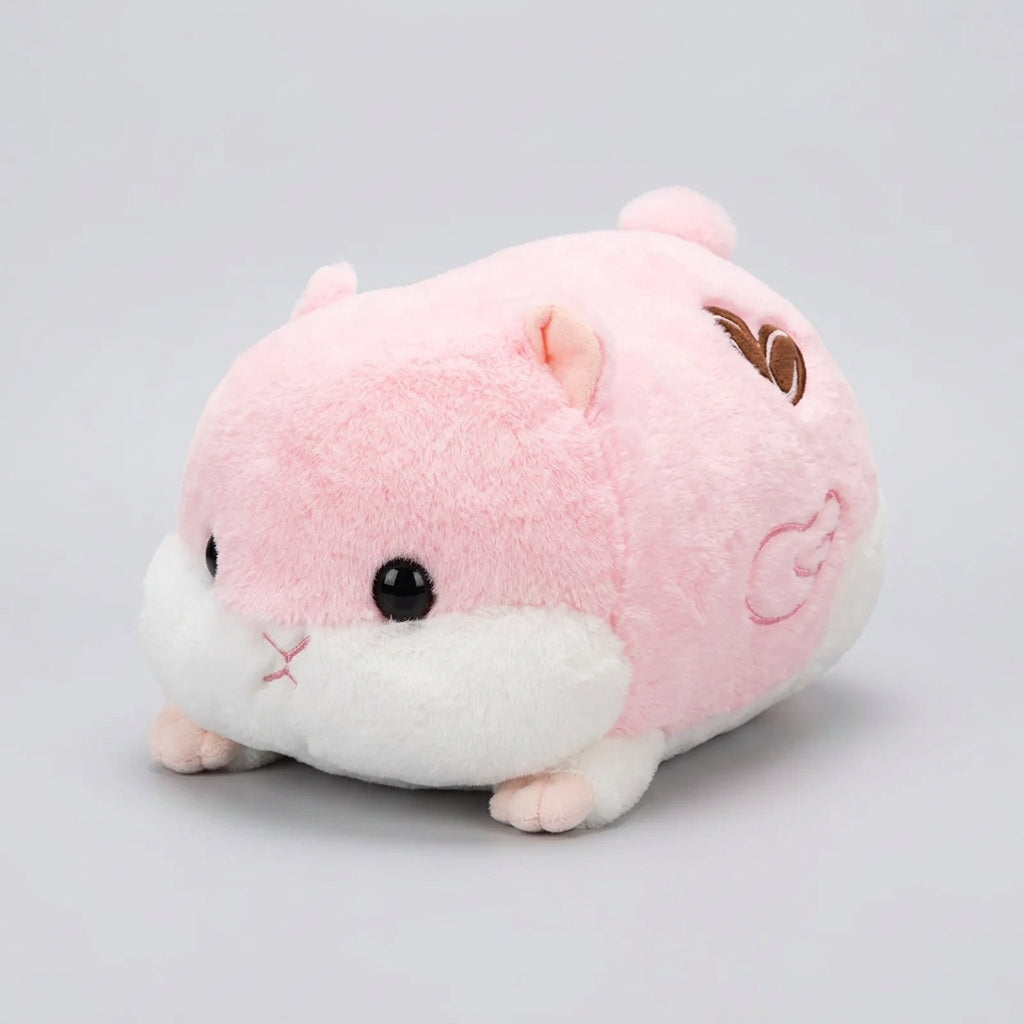 Plush toy resembling a pink and white animal on a wooden surface.