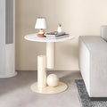 Modern side table with decorative items in a minimalistic room.