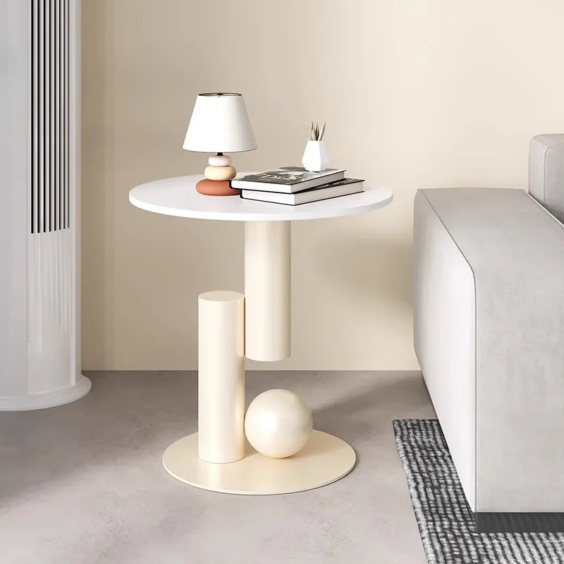 Modern side table with decorative items in a minimalistic room.