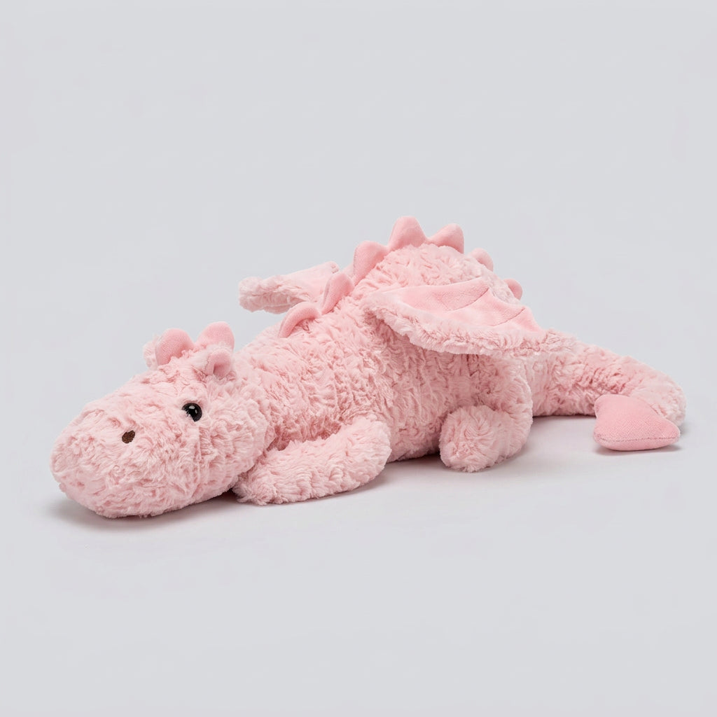 Pink plush dragon toy on a pink blanket
