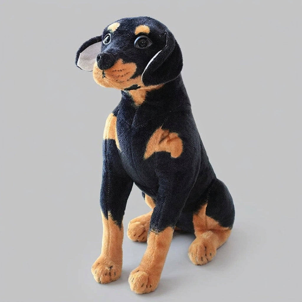 Plush toy dog with black and brown coloring on a white surface