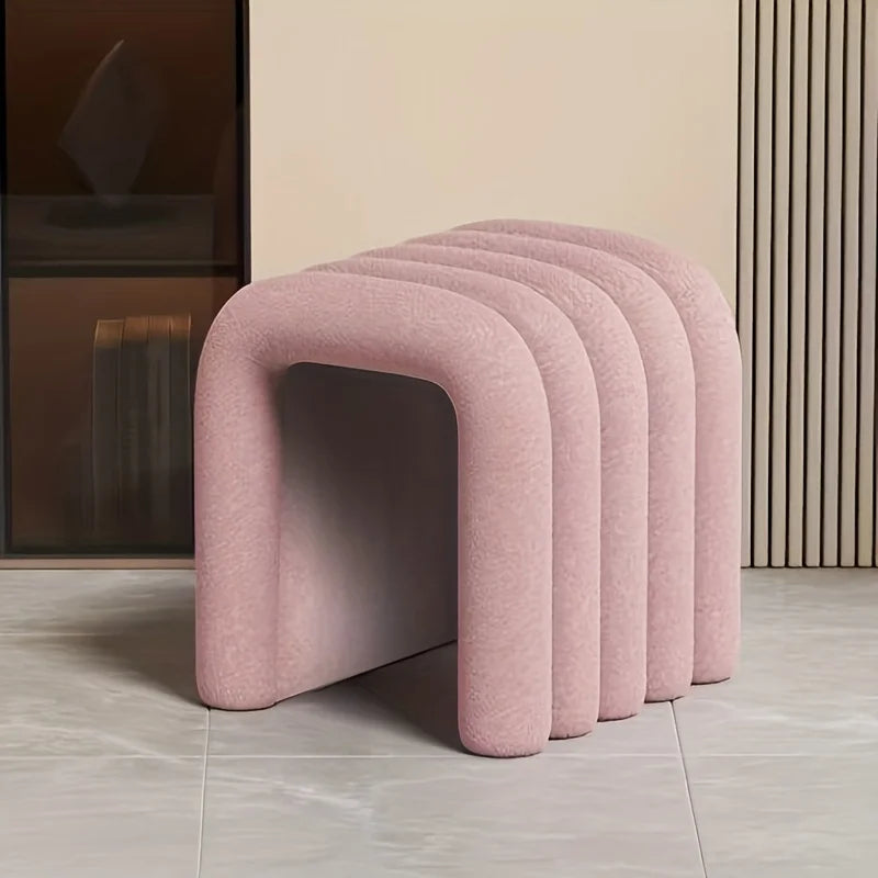 Row of pink stools against a neutral wall.
