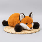 Plush fox toy on a woven mat with a blurred indoor background
