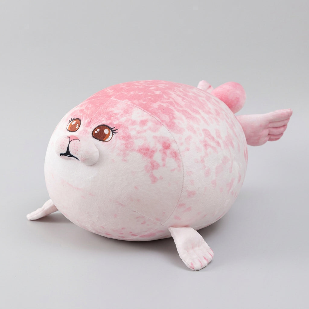 Pink plush toy resembling a seal on a woven mat with a light background