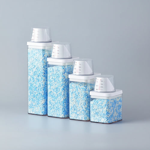 Set of glass canisters with blue and white contents on a white surface