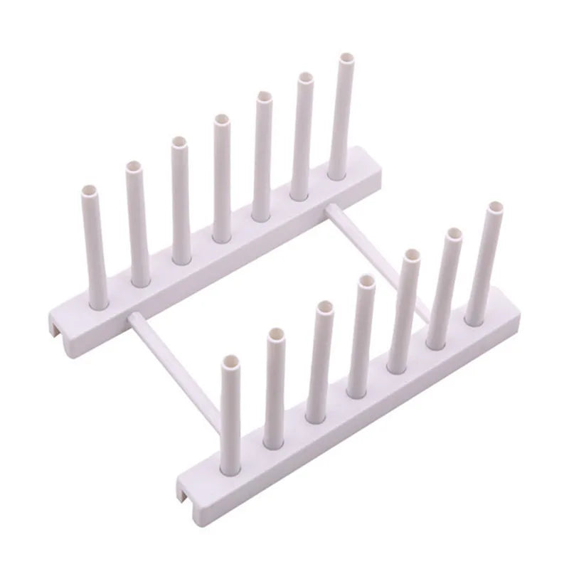 White plastic stand with multiple vertical rods on a white background